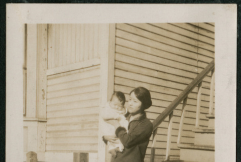 Woman and baby pose on boardwalk (ddr-densho-359-623)