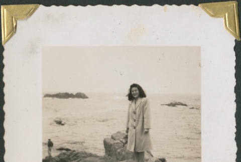 Woman standing on a rocky beach (ddr-densho-321-189)