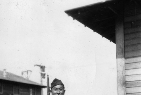 Joe Iwataki standing with rifle (ddr-ajah-2-756)