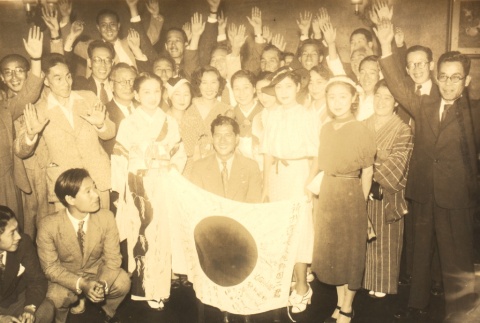 A group posing with a Japanese flag (ddr-njpa-4-2732)