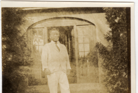Man in white suit standing by door (ddr-densho-426-1822)