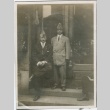 Two men standing in front of a business (ddr-densho-296-78)