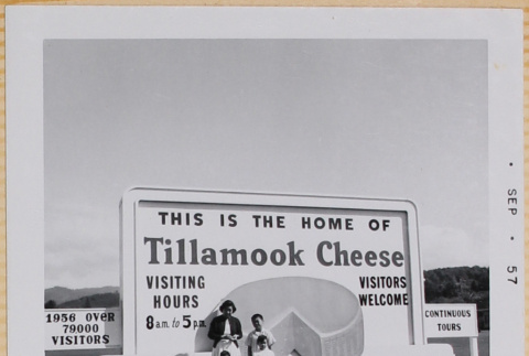 Yoshiko, William, Susan and Leslie Shiomi standing by sign for Tillamook Cheese Factory (ddr-densho-522-556)
