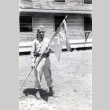 Sergeant Hachiro Hashiguchi holding the guidon for his unit, Company D of\nthe 100th Battalion of the 442nd Regimental Combat Team. (ddr-densho-474-235)