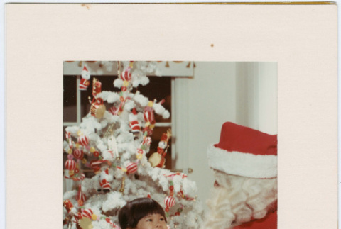 Photo folder with photo of girl with Santa (ddr-densho-430-317)