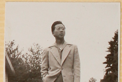 Man standing on gravel driveway (ddr-densho-522-18)