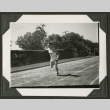 Man running in track event (ddr-densho-475-594)