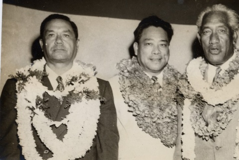 Duke Kahanamoku and other city officials posing with leis (ddr-njpa-2-492)