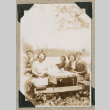 Group sitting at picnic table (ddr-densho-383-146)