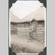 Man standing outside tent (ddr-ajah-2-410)