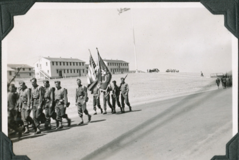 Group of men marching with flags (ddr-ajah-2-46)