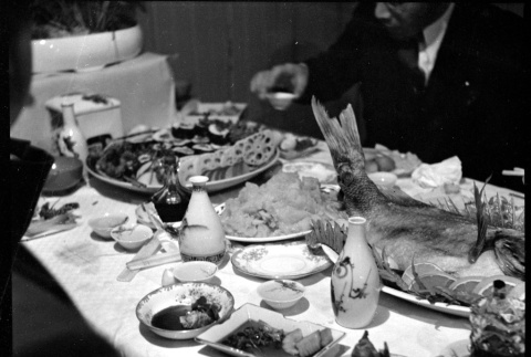 Table with various food and drink (ddr-densho-426-1705)
