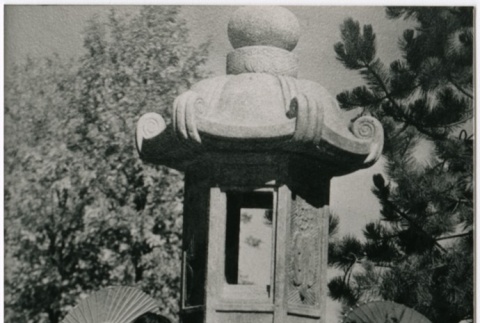 Two women pose with a stone lantern (ddr-densho-353-329)