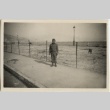 Japanese American soldier in front of barbed wire fence (ddr-densho-201-151)