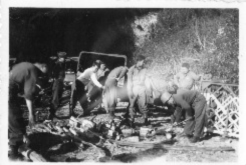 [Men in military uniform splitting firewood] (ddr-csujad-1-43)