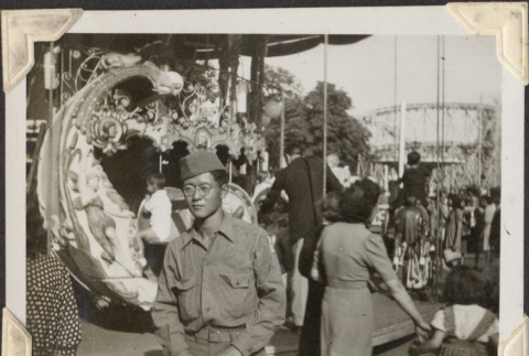 Man standing by carousel (ddr-densho-466-744)