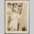 Two women sitting on fence (ddr-densho-523-18)