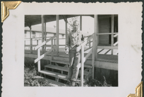Man standing on stairs outside building (ddr-densho-434-231)