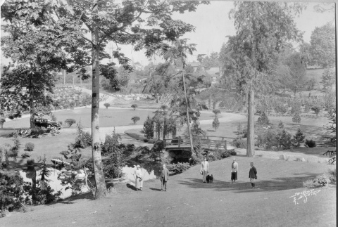 Visitors in the Garden near the Heart Bridge, Fujitaro Kubota on right, entrance in background.  View from the 