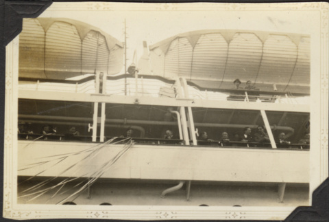 Group standing at railing on board ship (ddr-densho-326-551)