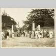 Men standing around a gateway (ddr-njpa-13-1265)