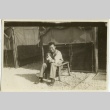 Soldier sitting outside tent with puppy (ddr-densho-201-93)