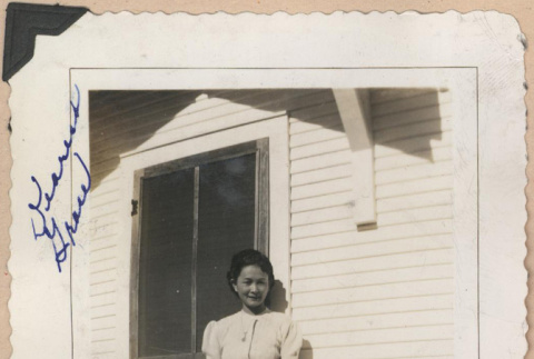 Signed photograph of a woman on a porch (ddr-manz-10-9)