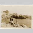 Tomoye (Nozawa) Takahashi and three men on rocky shore (ddr-densho-426-1782)
