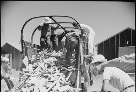Japanese Americans distributing scrap lumber (ddr-densho-37-360)