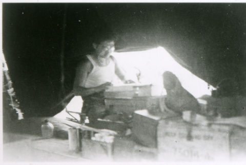 Man in tent with glasses (ddr-densho-1007-851)