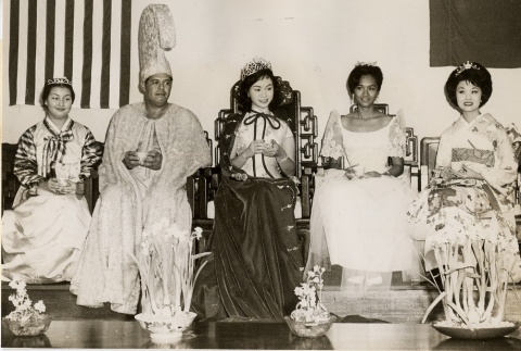 Queens of Asian cultural festivals and an Aloha Week king posing with cups of tea (ddr-njpa-2-565)