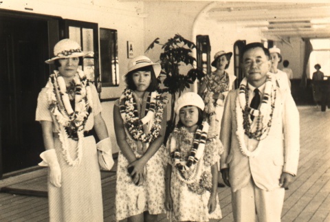 Kanekazu Okada and his family wearing leis (ddr-njpa-4-1985)