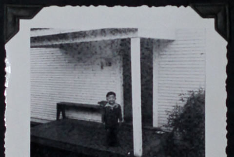 Boy poses on porch (ddr-densho-359-1548)