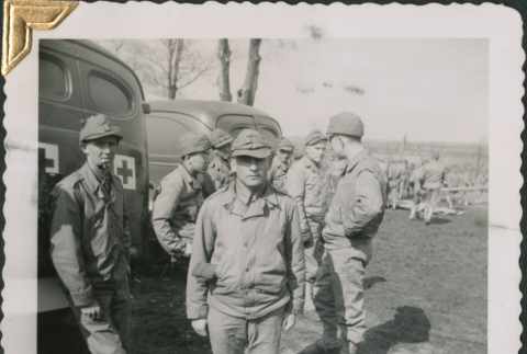 Group of men by army ambulances (ddr-densho-434-94)