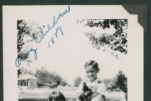four kids sitting on wagon (ddr-densho-378-726)