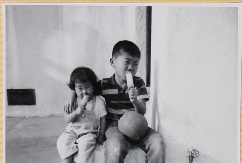 Susan and William Shiomi eating a popsicle (ddr-densho-522-274)