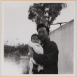 Susan Shiomi being held by a man (ddr-densho-522-140)