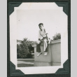 Man sitting atop wall (ddr-densho-475-558)
