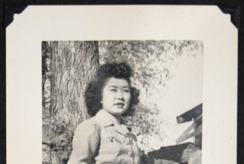 Nori poses next to firewood (ddr-densho-542-701)