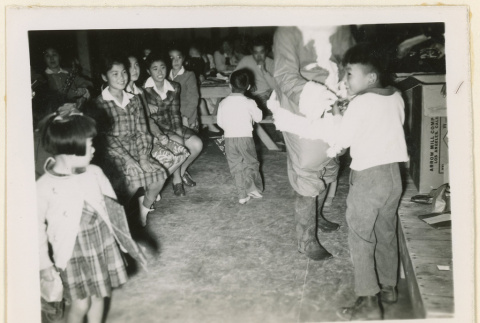 Children receive gifts from Santa Claus (ddr-densho-37-1305)