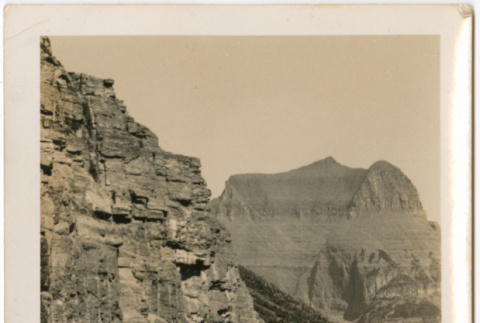 Man standing next to car on rough road near mountains (ddr-densho-426-1480)
