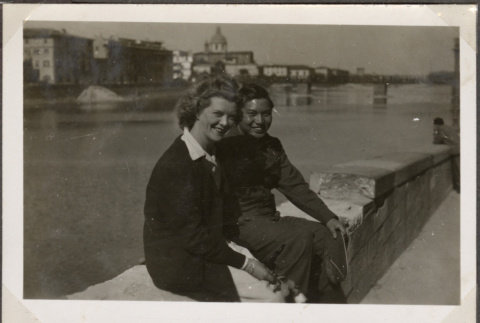 Man and woman sitting on wall by river (ddr-densho-466-64)