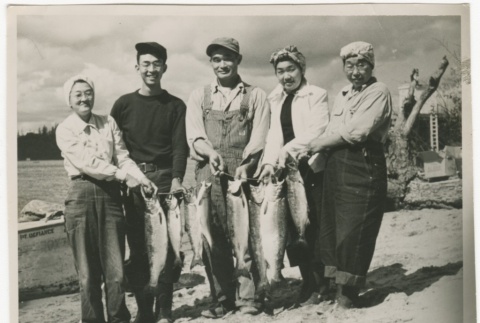 Group holding caught fish (ddr-densho-326-18)