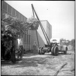 Men moving a large tree using a Neptune storage truck (ddr-densho-377-1551)