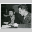 Young Japanese American signing voluntary enlistment papers (ddr-densho-122-752)