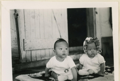 Watanabe twins seated on a blanket (ddr-densho-37-1430)