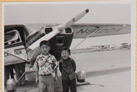 Two boys by airplane (ddr-densho-522-256)