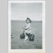 A toddler riding a tricycle (ddr-densho-300-83)