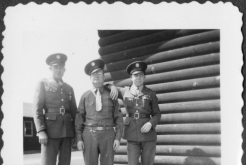 Three men standing outside building (ddr-densho-434-389)
