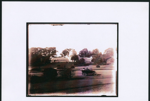 Car driving past Conservatory of Flower at Golden Gate Park (ddr-densho-423-459)